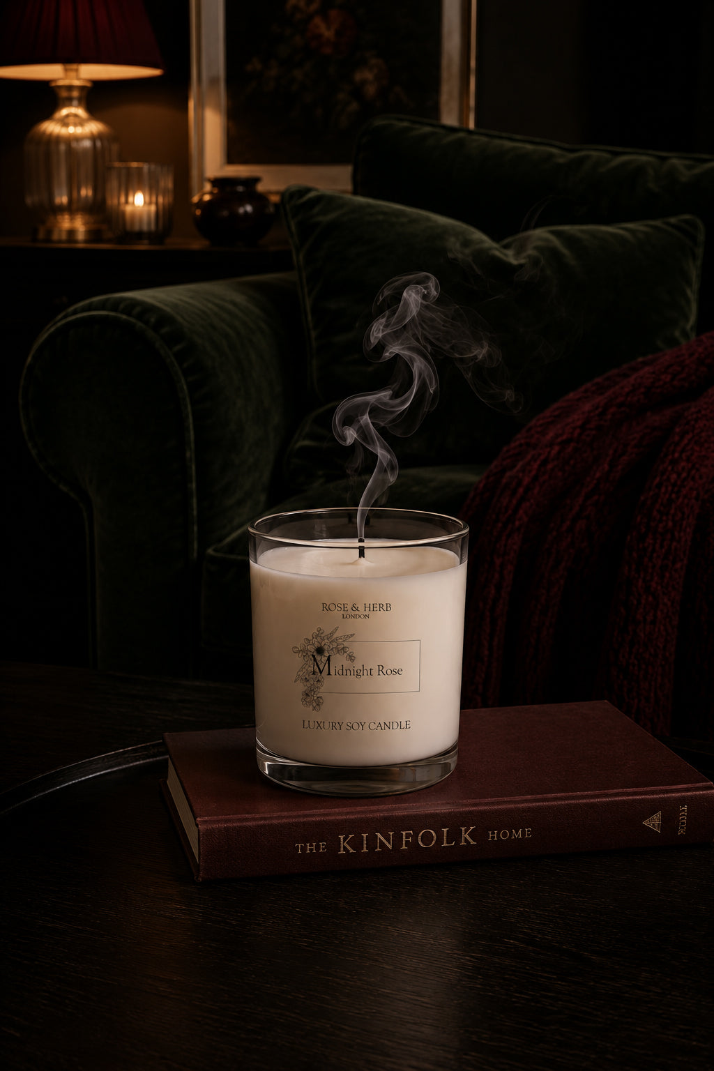 Midnight Rose Deluxe soy candle after burning in a dark cosy living room on top of Kinfolk book.